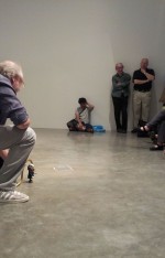 Hal Willner crouches to play with the Ginsberg bobblehead